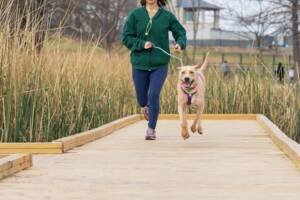 a girl running with a dog